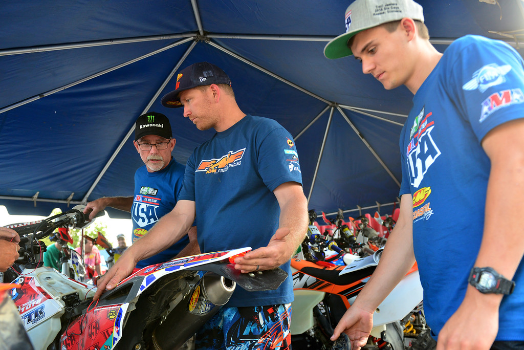 Tanner Harding and Jeff Fredette helping Josh work on his bike - photo by Art Pepin